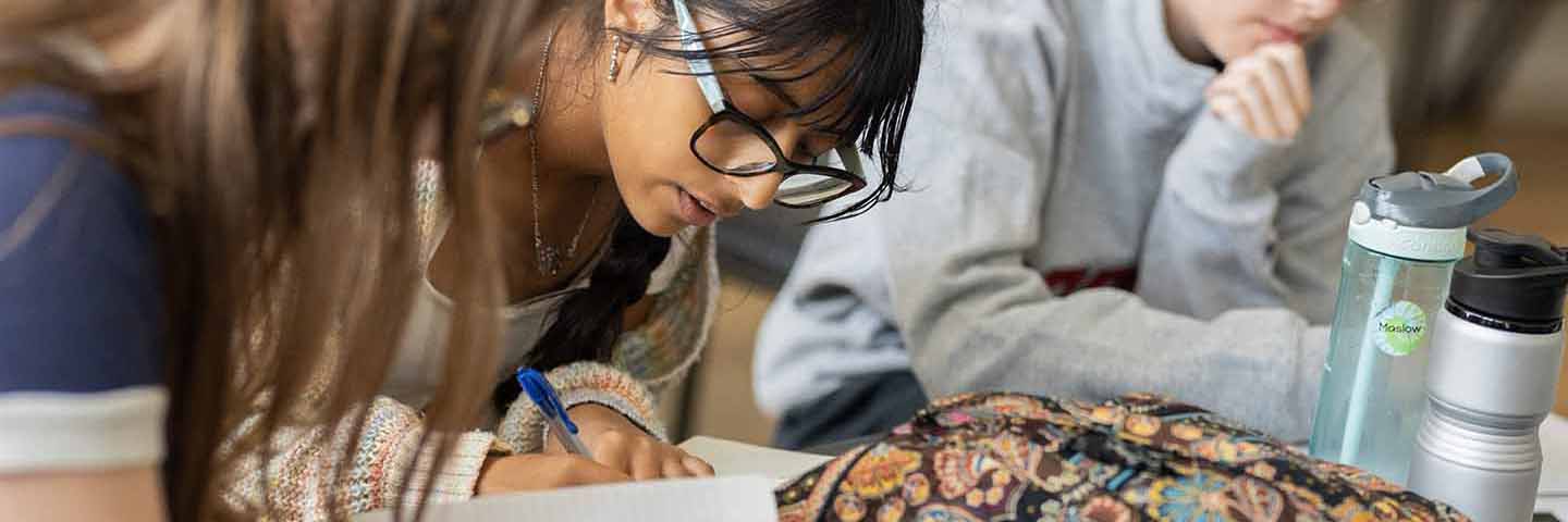 close up of student intently focused on writing